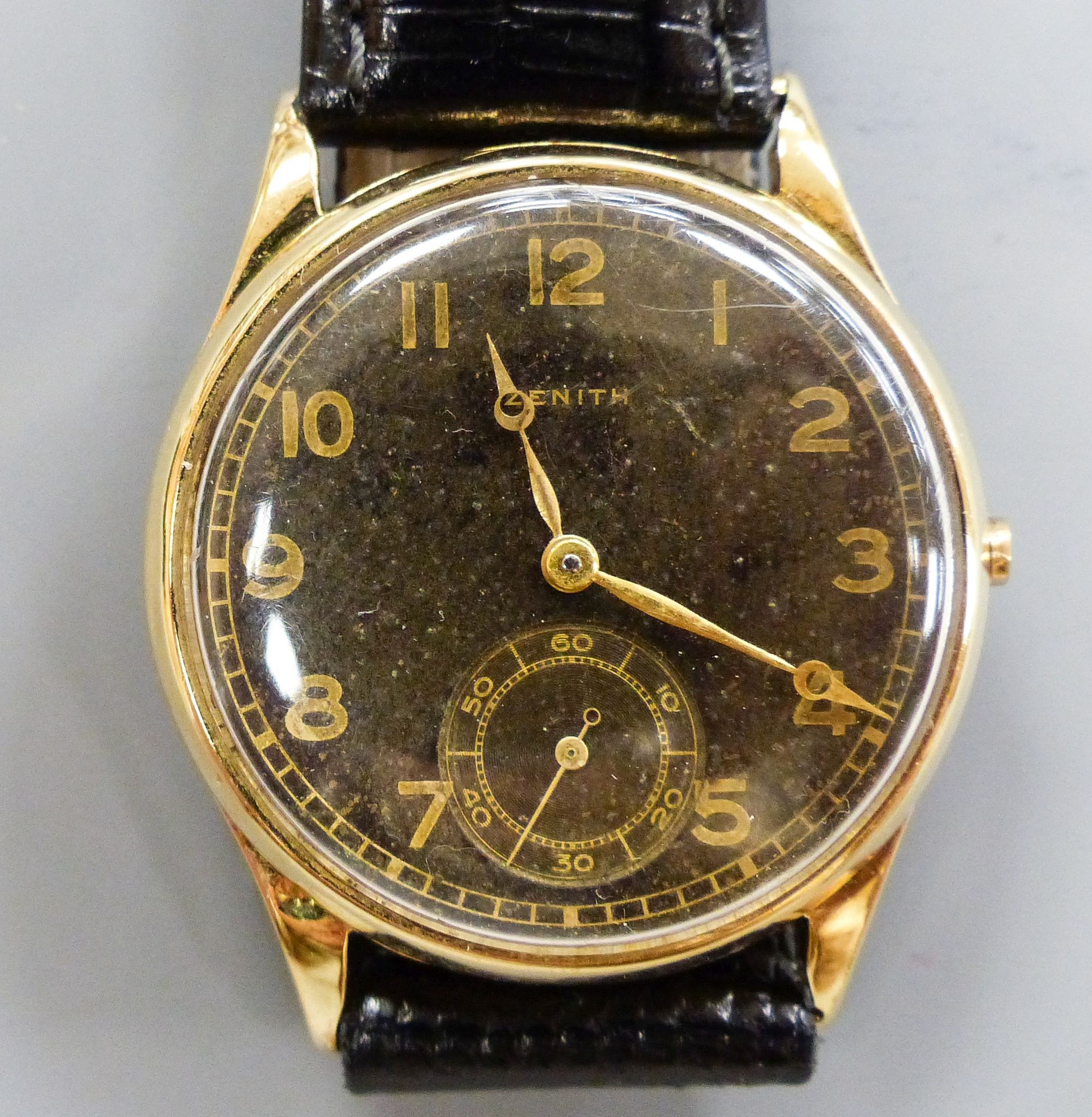 A gentleman's 14k yellow metal Zenith manual wind wrist watch, with subsidiary seconds, on later strap, winding crown loose but present